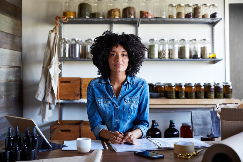 A shop owner standing behind the counter of her store